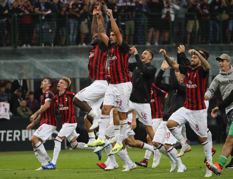 AC Milan's players celebrate their 2-1 win at the end of the Serie A soccer match between AC Milan and Roma at the Milan San Siro Stadium, Italy, Friday, Aug. 31, 2018. AC Milan won 2-1. (AP Photo/Antonio Calanni)