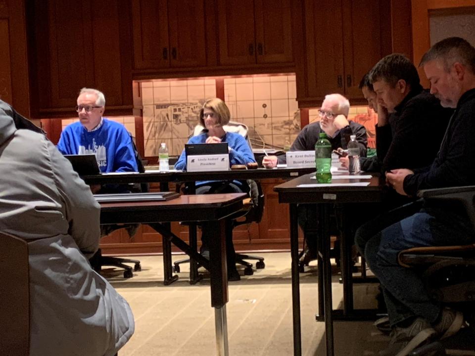 Perry School Board members Max Christensen and Linda Andorf and board secretary Kent Bultman listen to concerns from teachers about returning to class too soon following the school shooting on Jan. 4th.