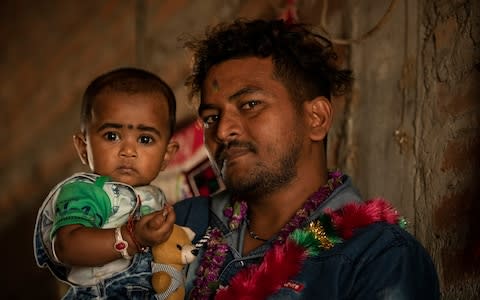 Rabindra Kewat and his 11-month-old daughter will be made homeless by January unless Mercury MENA pays him the wages - Credit: Simon Townsley/The Telegraph