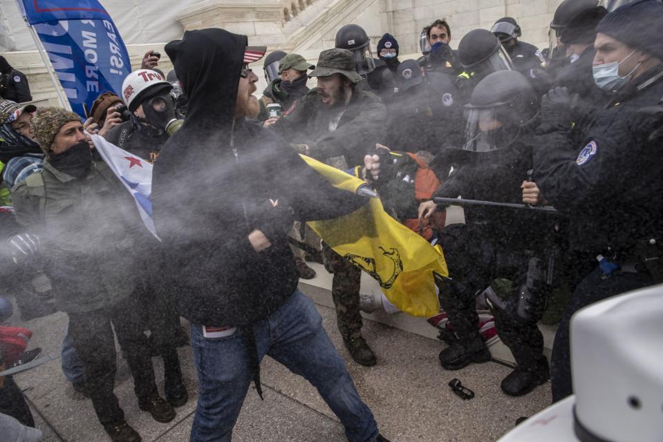 Pepper spray is used as rioters battle with U.S. Capitol police officers while breaching the Capitol building grounds in Washington, DC, U.S., on Wednesday, Jan. 6, 2021. The U.S. Capitol was placed under lockdown and Vice President Mike Pence left the floor of Congress as hundreds of protesters swarmed past barricades surrounding the building where lawmakers were debating Joe Biden's victory in the Electoral College. Photographer: Victor J. Blue/Bloomberg