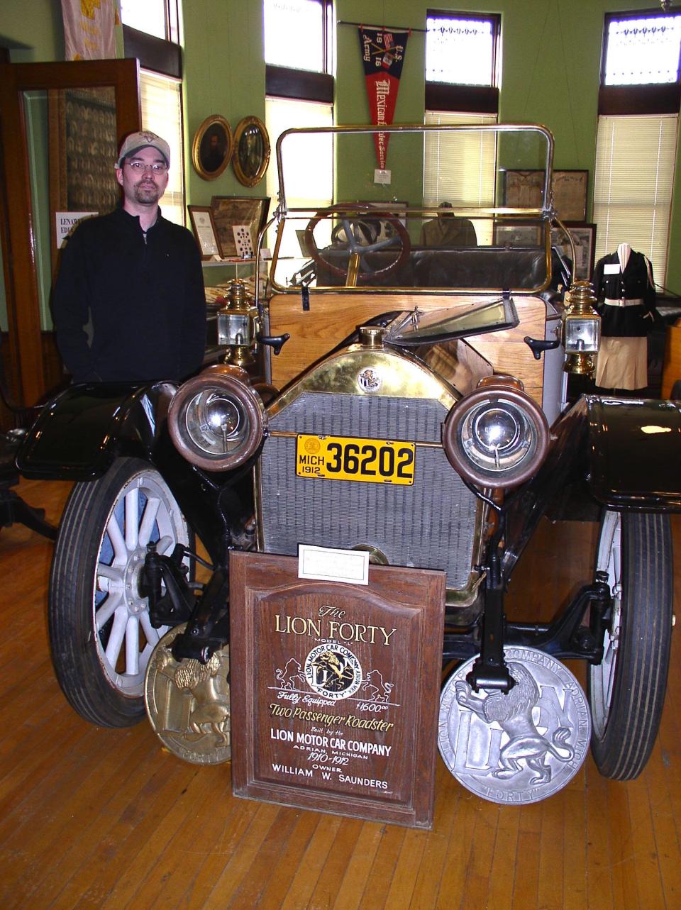 Daily Telegram history columnist Dan Cherry stands with the Lion 40 motor car nearly 20 years ago. The car is on permanent display at the Lenawee County Historical Society Museum in Adrian.