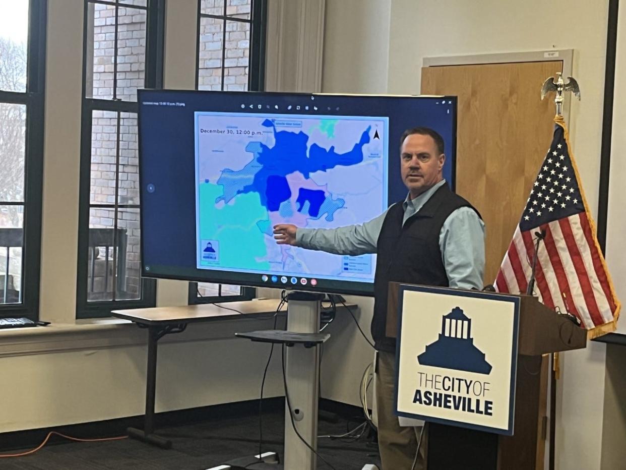 Water Director David Melton talks the press through a map showing the city's current water outage. People in Asheville and nearby communities first lost water Christmas Eve. It was unclear how many had no water as of noon Dec. 30.