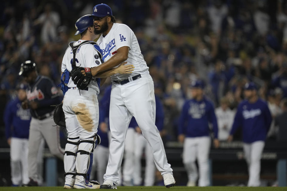 Los Angeles Dodgers catcher Will Smith congratulates pitcher Kenley Jansen after Game 5 of baseball's National League Championship Series against the Atlanta Braves Thursday, Oct. 21, 2021, in Los Angeles. The Dodgers defeated the Braves 11-2. The Braves lead the series 3-2 games. (AP Photo/Ashley Landis)