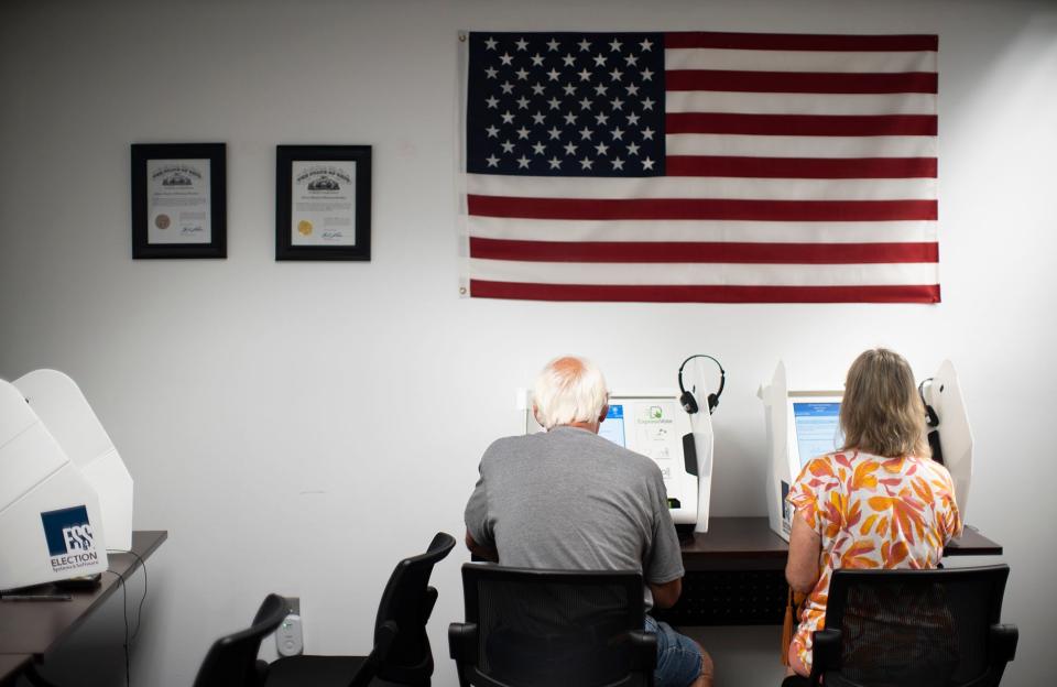 Jul 25, 2023; Athens, Ohio, USA;  Pam and Brian Rollins of Athens, vote on issue 1 during early voting at the Board of Elections in Athens County.