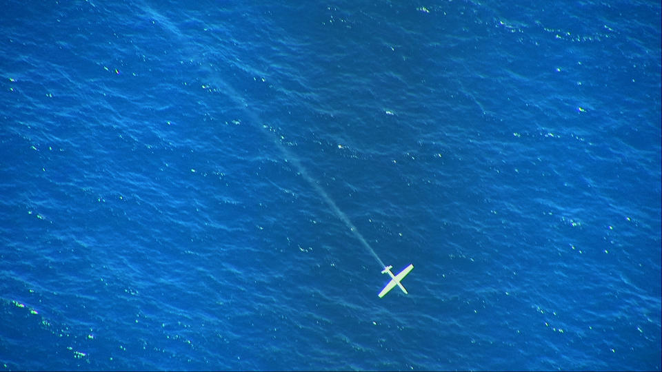 In this undated handout photo, provided by the Israeli Ministry of Defense, an unmanned airborne vehicle going down in the Mediterranean Sea after being struck by a high-power laser, over the Mediterranean Sea. The Israeli military said Monday, June 21, 2021, that it had successfully tested an airborne high-power laser that can shoot down drones, technology it hopes to deploy on a larger scale in the coming years. (Ministry of Defense Spokesperson’s Office via AP)