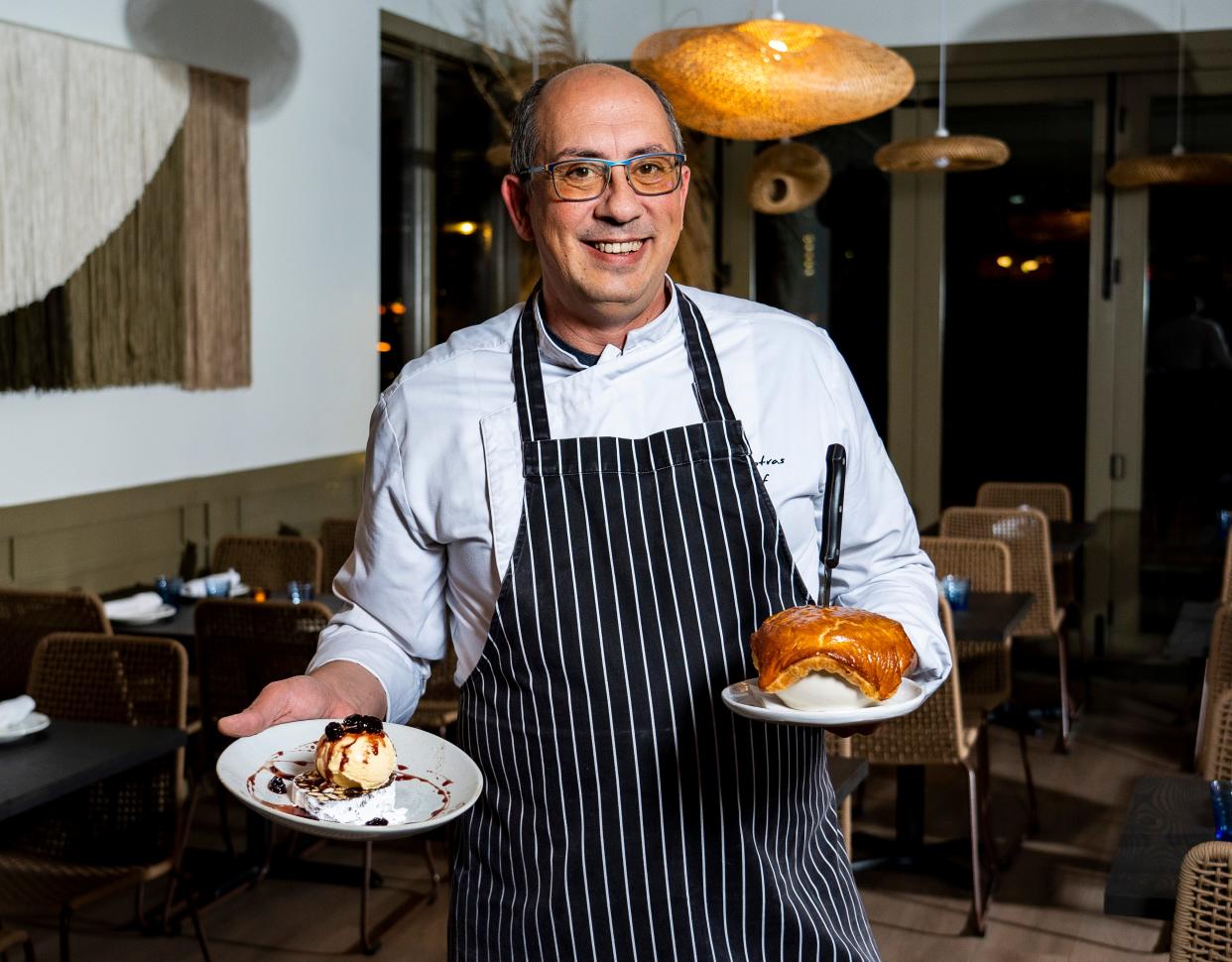 Executive Chef Babis Tsotras holds a Chocolate Mosaic, left, and a Beef Ragout Pie, right, at Avli, a restaurant specializing in regional Greek cuisine, on Dec. 1, 2023, in Milwaukee.