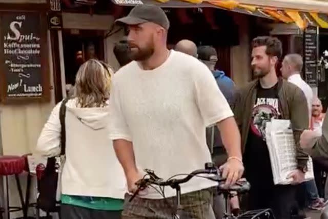 <p>Mark Gray for PEOPLE</p> Travis Kelce prepares to bike in Amsterdam on July 6, 2024