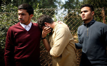 Colleagues of Palestinian journalist Yasser Murtaja, 31, who died of his wounds during clashes at the Israel-Gaza border on Friday, mourn during his funeral in Gaza city April 7, 2018. REUTERS/Suhaib Salem