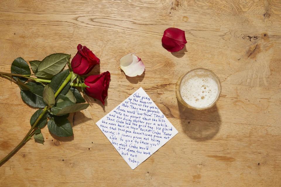 a note and flowers on a table