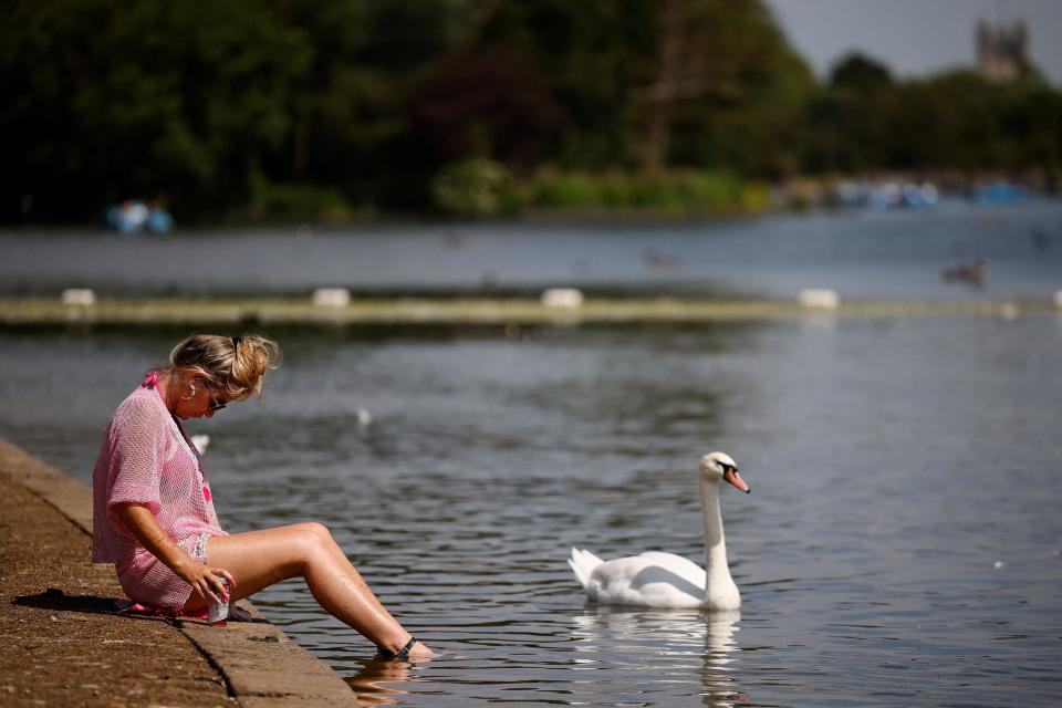 A woman paddles her feet in the Serpentine in Hyde Park (AFP/Getty)