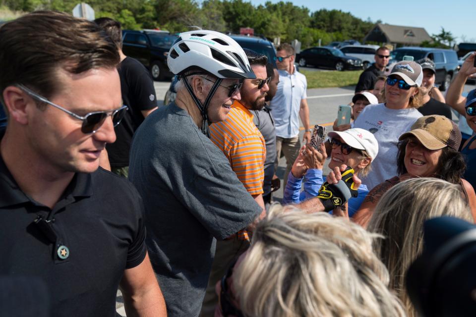 President Joe Biden talks to a crowd after falling from his bike in Rehoboth Beach, Del., on June 18, 2022.