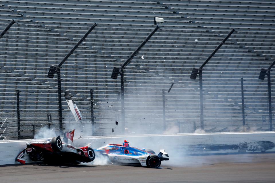 Rahal Letterman Lanigan Racing driver Katherine Legge (44) and Dreyer & Reinbold Racing driver Stefan Wilson (24) crash in the first turn Monday, May 22, 2023, during practice ahead of the 107th running of the Indianapolis 500 at Indianapolis Motor Speedway. 