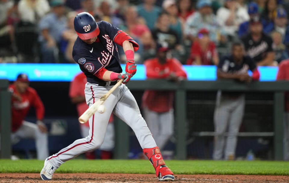 Washington Nationals' Lane Thomas hits a two-run double against the Seattle Mariners during the 11th inning of a baseball game Tuesday, June 27, 2023, in Seattle. The Nationals won 7-4. (AP Photo/Lindsey Wasson)