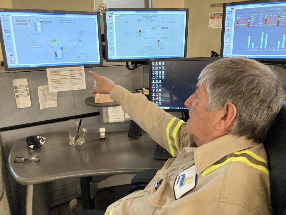 This Sept. 20, 2022 image shows Albert Gonzales monitoring pollution control systems during the final week of operations at the San Juan Generating Station near Waterflow, New Mexico. Gonzales, 70, worked 40 years for Public Service Co. of New Mexico, the utility that ran the coal-fired power plant. (AP Photo/Susan Montoya Bryan)