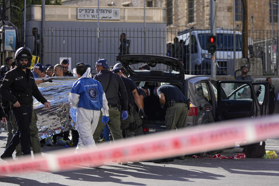 Israeli police examine the scene of a car ramming attack, in Jerusalem, Monday, April 24, 2023. Israeli Prime Minister Benjamin Netanyahu says multiple people have been attacked and wounded near a popular market in Jerusalem. (AP Photo/Ohad Zwigenberg)