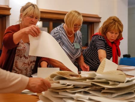 Members of a local electoral commission count ballots at a polling station after a parliamentary election in Kiev