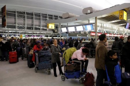 FILE PHOTO: Passengers line up to check-in at the departures area of Terminal 4 at John F. Kennedy International Airport in New York City, U.S. January 7, 2018.  REUTERS/Andrew Kelly