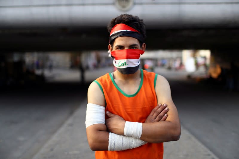 Mohammad, an Iraqi demonstrator, poses for a photograph during the ongoing anti-government protests in Baghdad