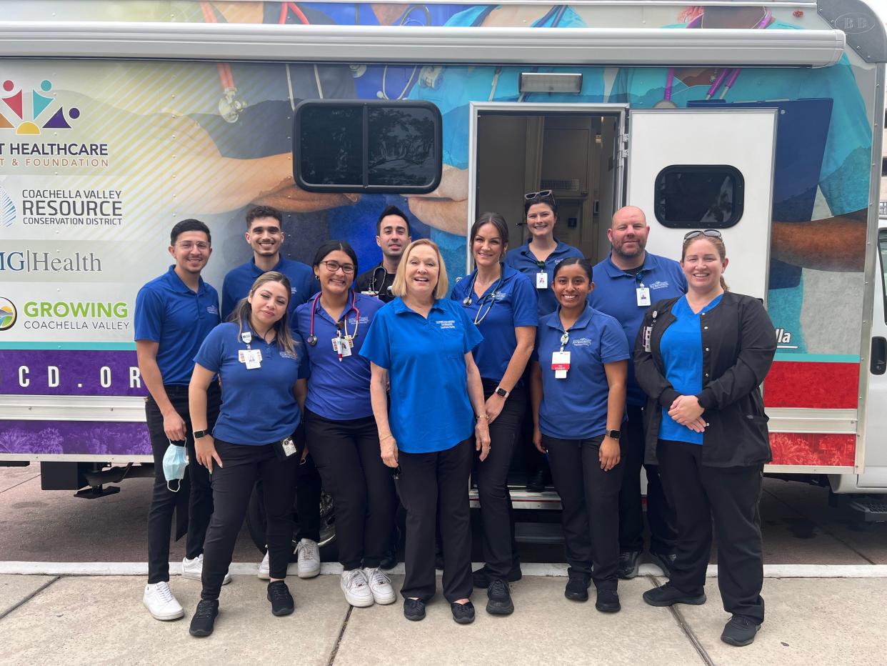 Members of the CSUSB Nursing Street Medicine Program pose in front of a mobile medical clinic.