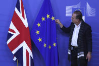 The Union flag and EU flag are adjusted prior to the arrival of the British Prime Minister Theresa May at EU headquarters in Brussels, Tuesday, Dec. 11 2018. Top European Union officials on Tuesday ruled out any renegotiation of the divorce agreement with Britain, as Prime Minister Theresa May fought to save her Brexit deal by lobbying leaders in Europe's capitals. (AP Photo/Francisco Seco)