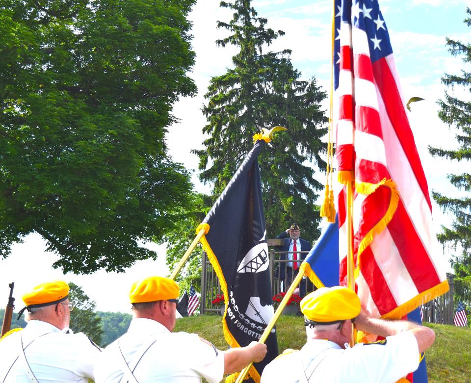 The color guard displays the flag for the during the playing of the national anthem In Millersburg.