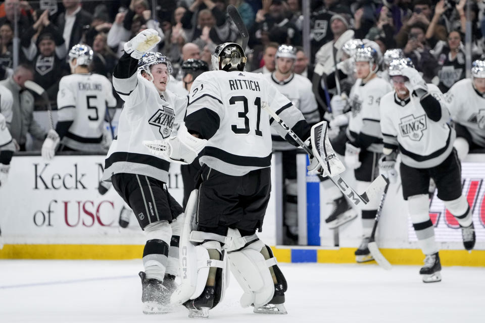 Los Angeles Kings goaltender David Rittich, center, celebrates with defenseman Brandt Clarke after blocking a shot by Anaheim Ducks left wing Alex Killorn to end the shootout in an NHL hockey game Saturday, Feb. 24, 2024, in Los Angeles. (AP Photo/Ryan Sun)