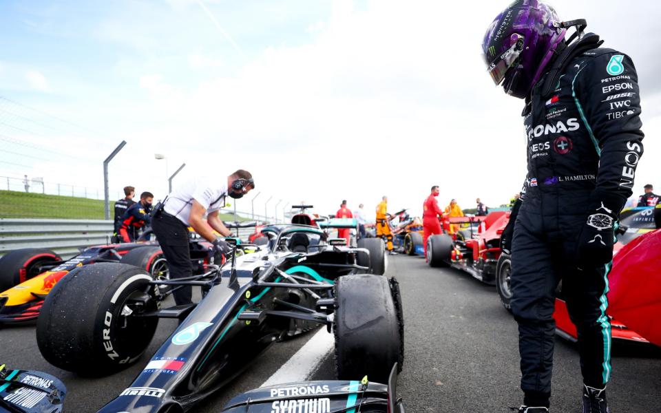 Lewis Hamilton of Great Britain and Mercedes GP inspects his punctured tyre in parc ferme after the Formula One British Grand Prix at Silverstone on August 02, 2020  - Dan Istitene - Formula 1