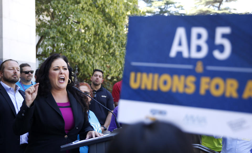 Assemblywoman Lorena Gonzalez, D-San Diego, speaks at a rally after her measure to limit when companies can label workers as independent contractors was approved by a Senate committee, in Sacramento, Calif., Wednesday, July 10, 2019. The measure, AB5, is aimed at major employers like Uber and Lyft. (AP Photo/Rich Pedroncelli)