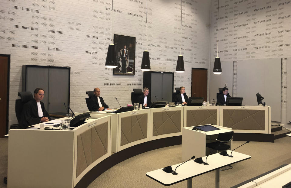 Judging panel preside in the court case for on a 74-year-old woman suffering from dementia who was euthanized three years ago despite some indications that she might have changed her mind, as the trial opens in The Hague, Netherlands Monday Aug. 26, 2019. The landmark euthanasia trial seeks to pinpoint what to do with dementia patients who have previously stated their wish to die under certain circumstances but later might have second thoughts. (AP PHoto/Aleks Furtula)