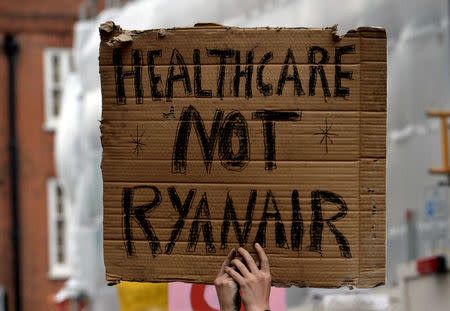 FILE PHOTO: Demonstrators hold a sign outside Ireland's embassy as they support the demand for more liberal Irish abortion laws, in London, Britain September 30, 2017. REUTERS/Mary Turner/File Photo