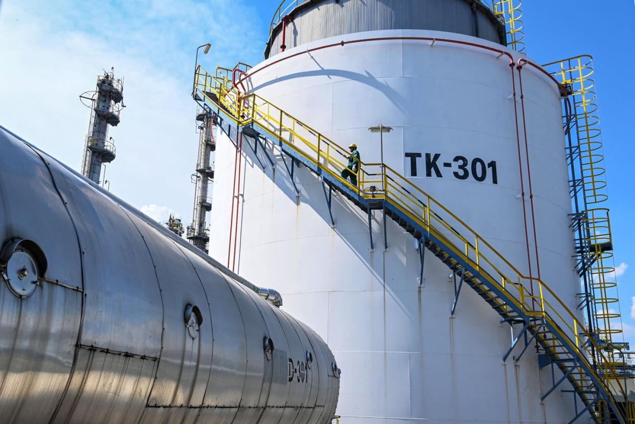 <span class="caption">An oil tank at Hungary's Duna Refinery, which receives Russian crude oil through the Druzhba pipeline. </span> <span class="attribution"><a class="link " href="https://www.gettyimages.com/detail/news-photo/worker-takes-the-stairs-outside-a-giant-tank-at-the-duna-news-photo/1240503355" rel="nofollow noopener" target="_blank" data-ylk="slk:Attila Kisbenedek/AFP via Getty Images;elm:context_link;itc:0;sec:content-canvas">Attila Kisbenedek/AFP via Getty Images</a></span>