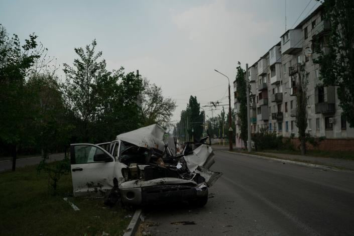 A badly damaged car is seen on a street after a Russian attack in Severodonetsk, Ukraine's Luhansk region, Friday, May 13, 2022. (Leo Correa/AP)