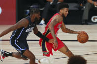 New Orleans Pelicans guard Nickeil Alexander-Walker (0) dribbles the ball against Orlando Magic forward James Ennis III (11) during the first half of an NBA basketball game Thursday, Aug. 13, 2020, in Lake Buena Vista, Fla. (Kim Klement/Pool Photo via AP)