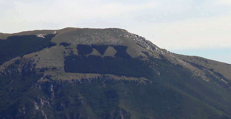 <span class="caption">A woody homage to Mussolini – the fascist leader’s title in Latin is DUX.</span> <span class="attribution"><a class="link " href="https://commons.wikimedia.org/wiki/File:Monte_Giano_-_bosco_DUX_da_Calcariola_01.png" rel="nofollow noopener" target="_blank" data-ylk="slk:Marco Miluzzi / YouTube: Rieti e provincia;elm:context_link;itc:0;sec:content-canvas">Marco Miluzzi / YouTube: Rieti e provincia</a>, <a class="link " href="http://creativecommons.org/licenses/by-sa/4.0/" rel="nofollow noopener" target="_blank" data-ylk="slk:CC BY-SA;elm:context_link;itc:0;sec:content-canvas">CC BY-SA</a></span>