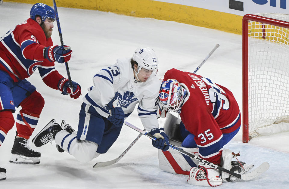 Toronto Maple Leafs' Matthew Knies (23) moves in on Montreal Canadiens goaltender Sam Montembeault as Canadiens' David Savard defends during the first period of an NHL hockey game Saturday, March 9, 2024, in Montreal. (Graham Hughes/The Canadian Press via AP)