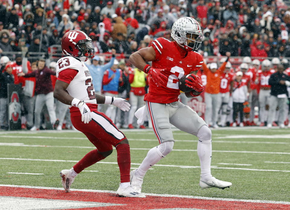 Ohio State wide receiver Emeka Egbuka, right, scores a touchdown in front of Indiana defensive back Jaylin Williams during the first half of an NCAA college football game Saturday, Nov. 12, 2022 in Columbus, Ohio. (AP Photo/Paul Vernon)