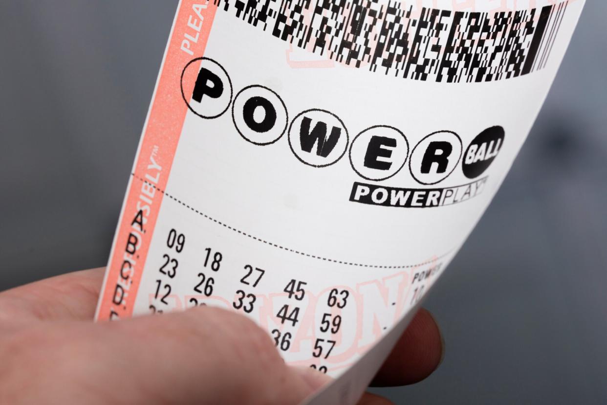 January 20, 2016: A photo of a man holding a Powerball lottery ticket in Kingman, Arizona.