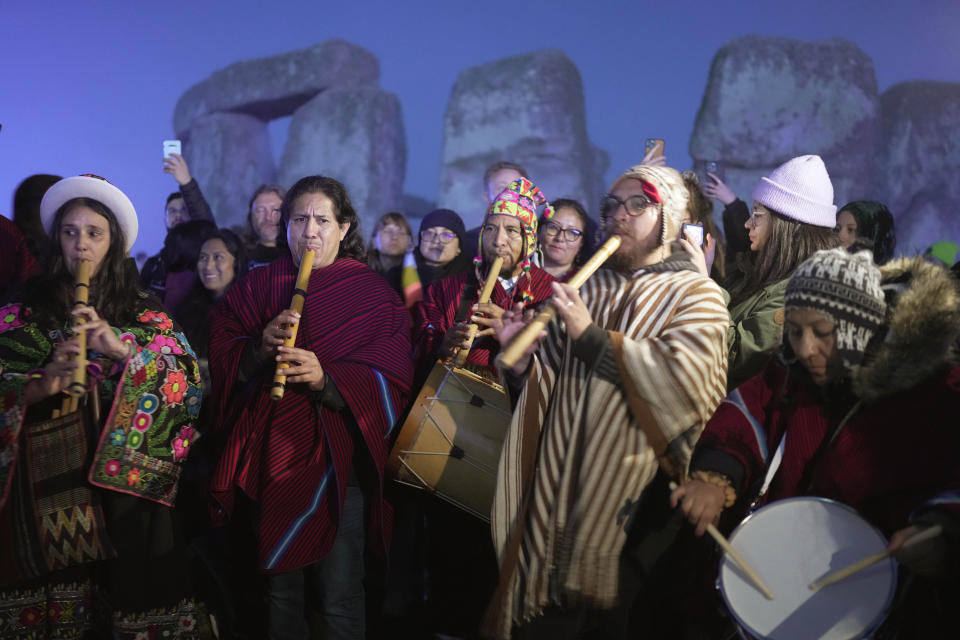 Revelers gather at the ancient stone circle Stonehenge to celebrate the Summer Solstice, the longest day of the year, near Salisbury, England, Wednesday, June 21, 2023. (AP Photo/Kin Cheung)