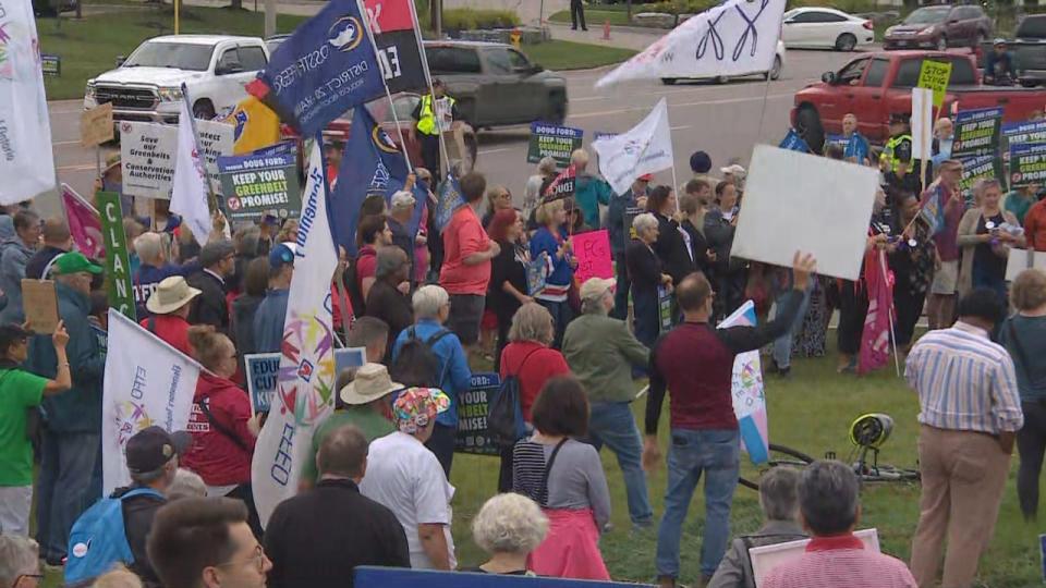 Dozens of protesters held signs and voiced their concerns about the Greenbelt controversy outside of the Ford Fest event that took place on Friday in Kitchener.