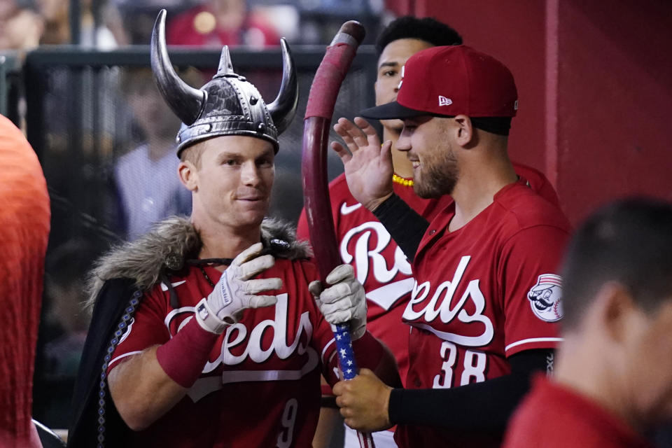 Cincinnati Reds' Matt McLain (9) celebrates after his home run against the Arizona Diamondbacks with teammate Michael Siani (38) during the sixth inning of a baseball game Saturday, Aug. 26, 2023, in Phoenix. (AP Photo/Ross D. Franklin)