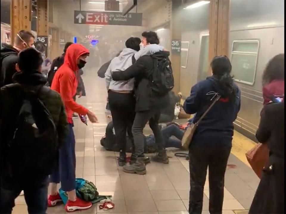 A person is aided outside a subway car in the Brooklyn borough of New York, Tuesday, April 12, 2022 in this photo provided by Will B Wylde.