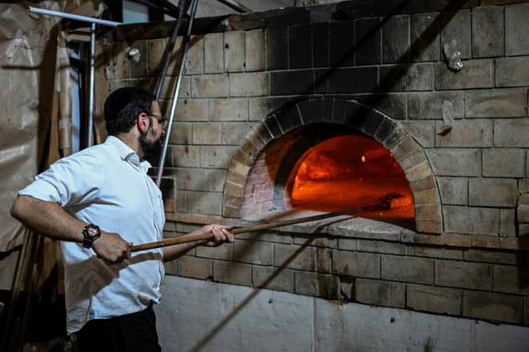 An Ultra-Orthodox Jew prepares Matzoth, unleavened bread, at a Jerusalem bakery on the eve of Passover (RONALDO SCHEMIDT)
