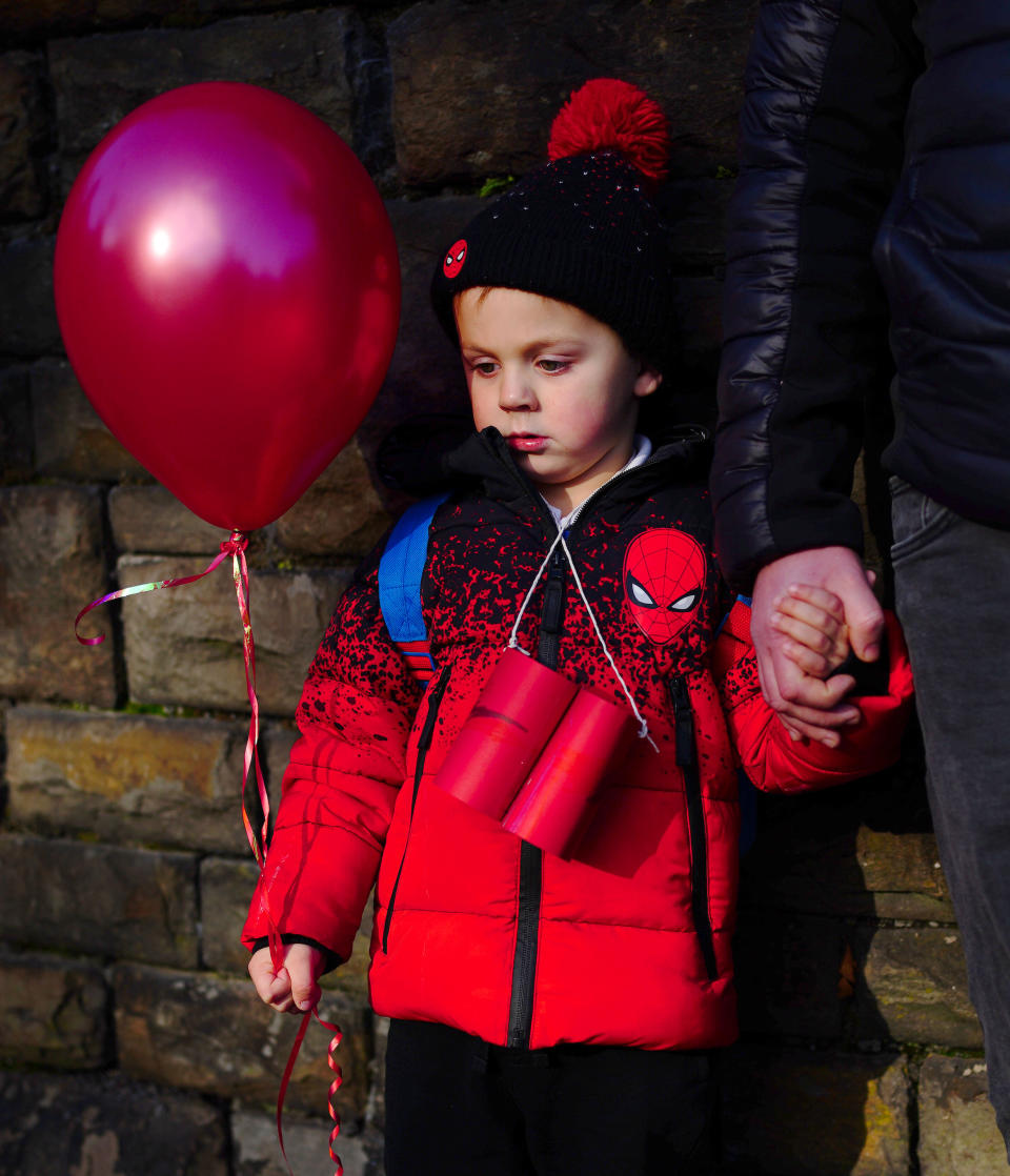 Connor (aged 4) holds a red balloon as the funeral procession of Jack Lis arrives at St Martin's Church, Caerphilly. Picture date: Thursday November 25, 2021.