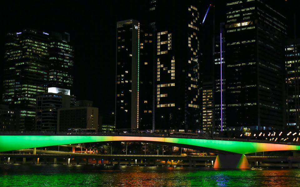 'BNE 2032' is displayed on a building during the announcement of the host city for the 2032 Olympic Games