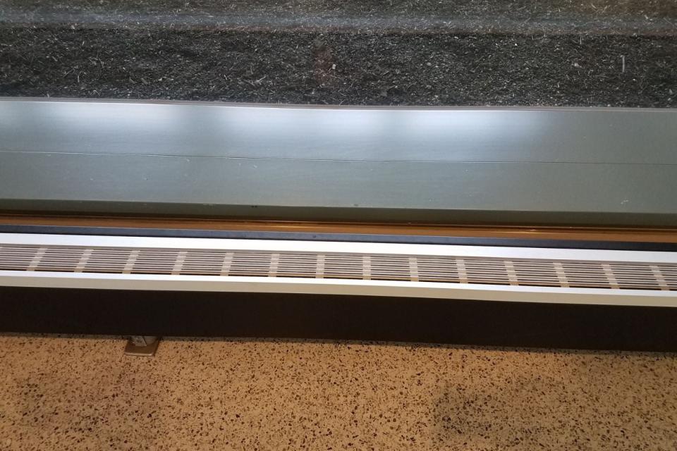 A close-up of a baseboard heating unit in a modern home.