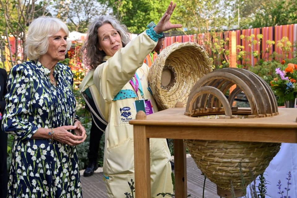 Queen Camilla views a bee house with beekeeper Paula Carnell (PA)