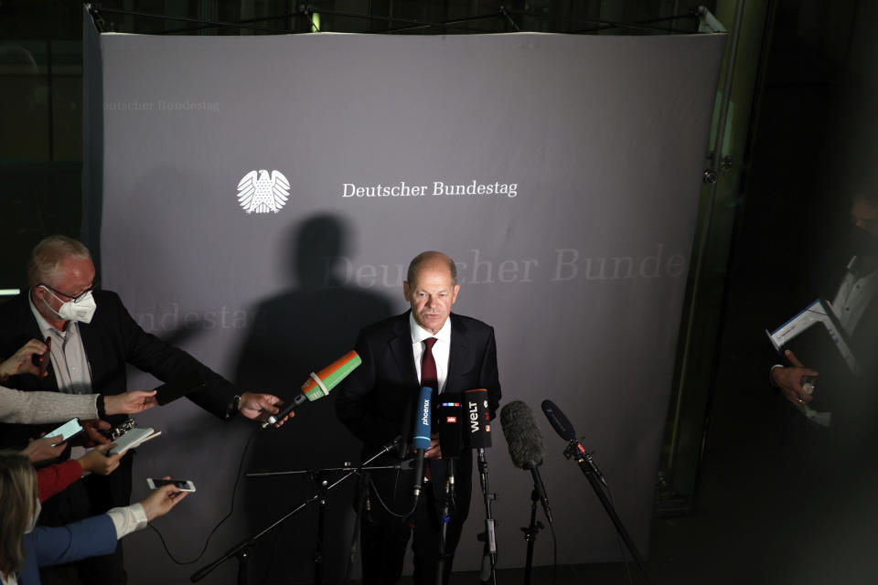 Olaf Scholz, Federal Minister of Finance, and SPD top candidate for chancellor at the forthcoming elections, speaks to journalists after the hearing before the Bundestag Finance Committee in Berlin, Germany, Monday, Sept. 20, 2021. Scholz was to answer questions about the search of his ministry in connection with money laundering investigations. (Carsten Koall/dpa via AP)