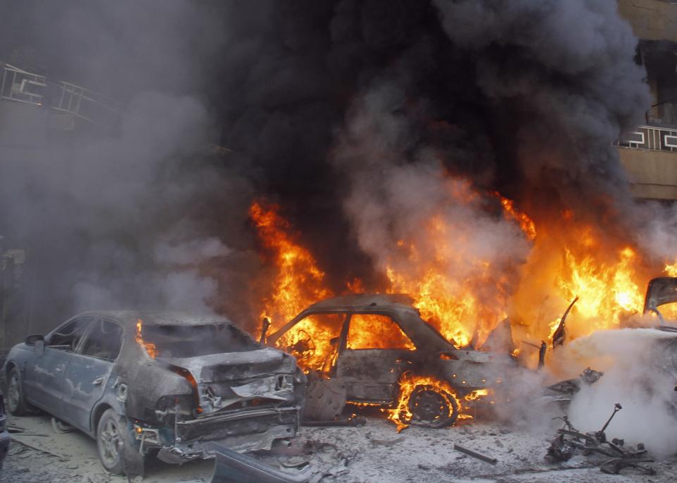 Cars burn following an explosion in the Haret Hreik area in the southern suburbs of Beirut