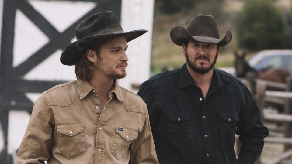 Kayce and Rip in hats on ranch in Yellowstone