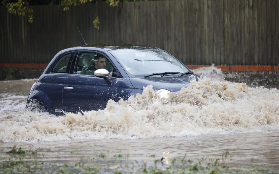 Car drives through floods in West Sussex